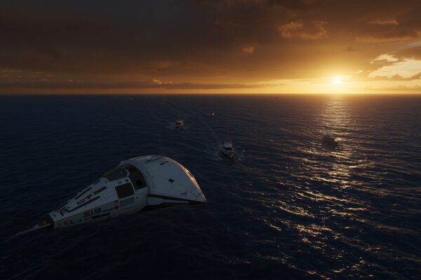Orion spacecraft capsule floating in the Pacific Ocean after Artemis II splashdown at sunset