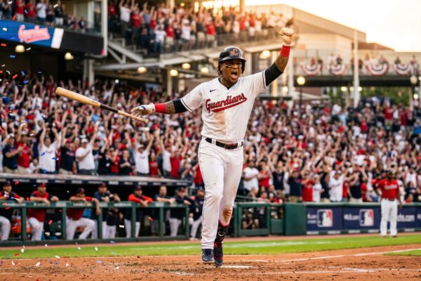 Young baseball player celebrating a home run in a packed stadium