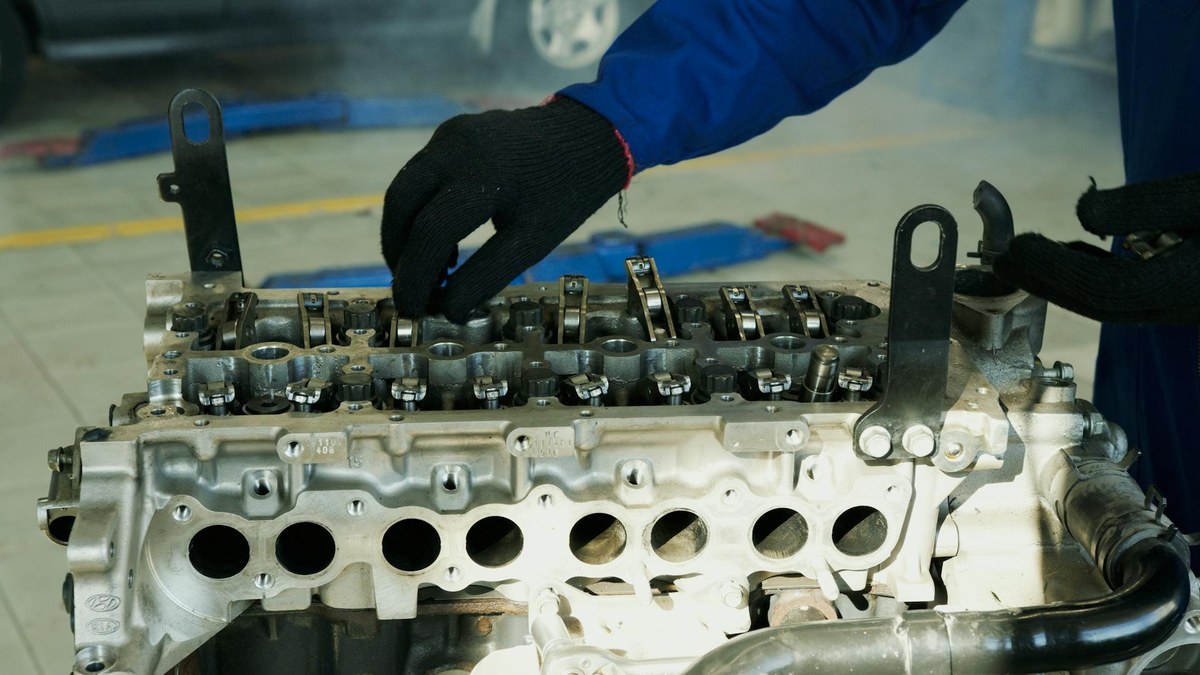 Hands fixing a small engine - close-up of carburetor and spark plug work covered in this guide