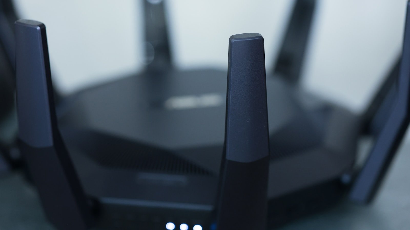 Close-up of a wireless router with antennas extended for WiFi signal coverage