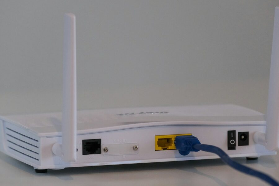 White wireless router on a table — WiFi keeps dropping repair guide