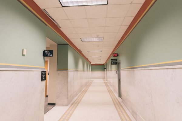Empty fluorescent-lit corridor evoking a liminal space, illustrating the Backrooms box office record story