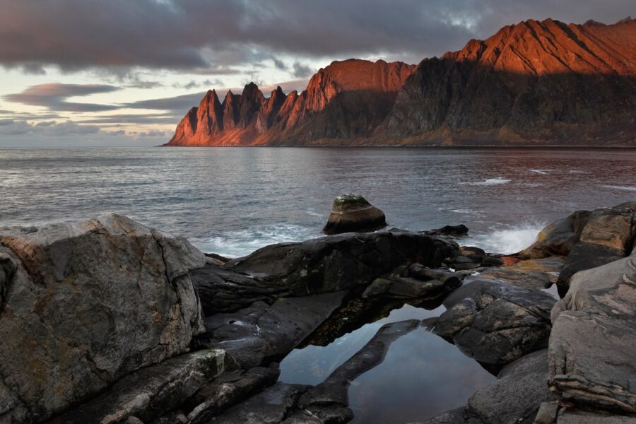 Dramatic Nordic mountains and fjord at golden hour