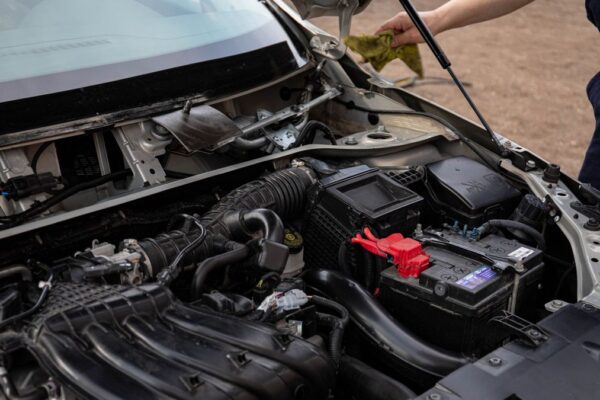 Inspecting a car engine bay after a check engine light
