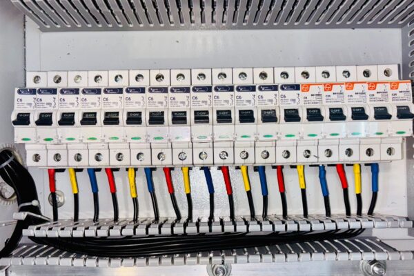 Homeowner using a non-contact voltage tester at an open residential electrical breaker panel with power off — circuit breaker troubleshooting safety