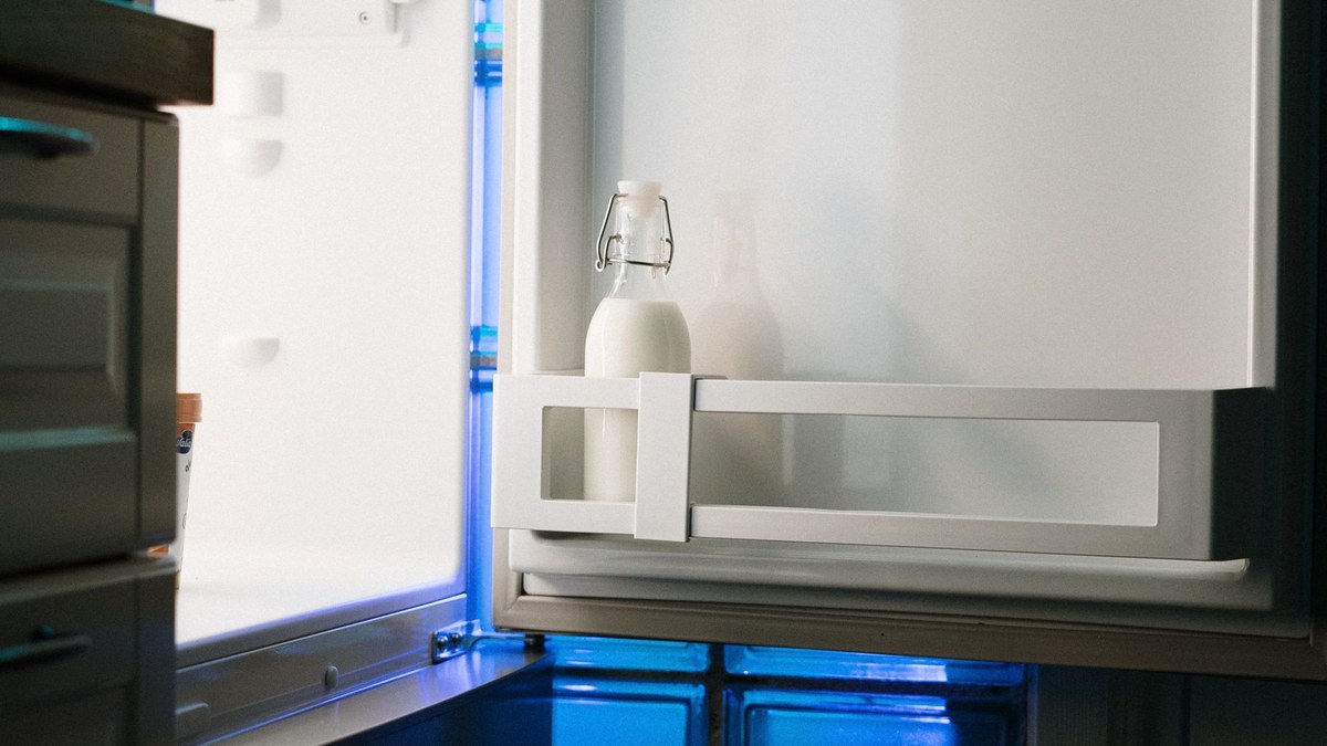 Inside of an open refrigerator while checking why it is not cooling properly