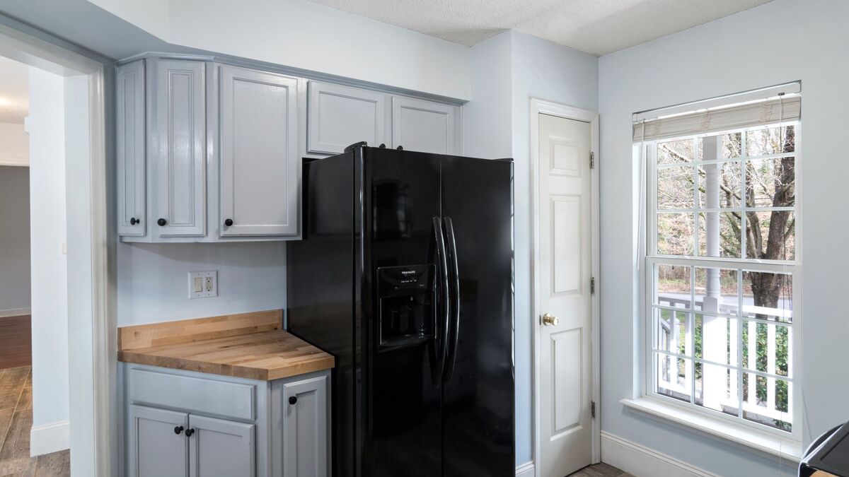 Modern refrigerator unit in a kitchen with freezer running but fridge not cold