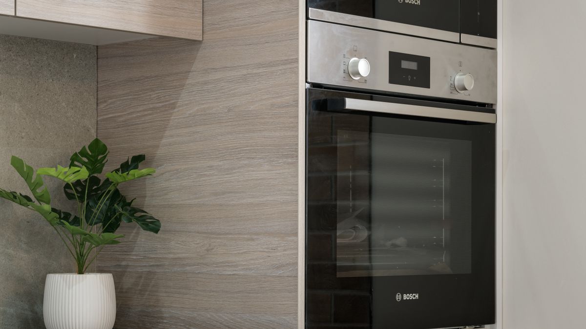 Built-in microwave in a kitchen, checking the door latch and switches
