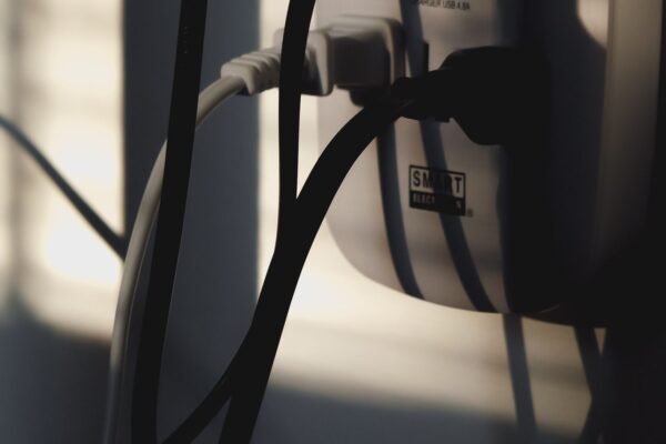 Household wall outlet with plugs inserted, used to diagnose why an outlet has no power